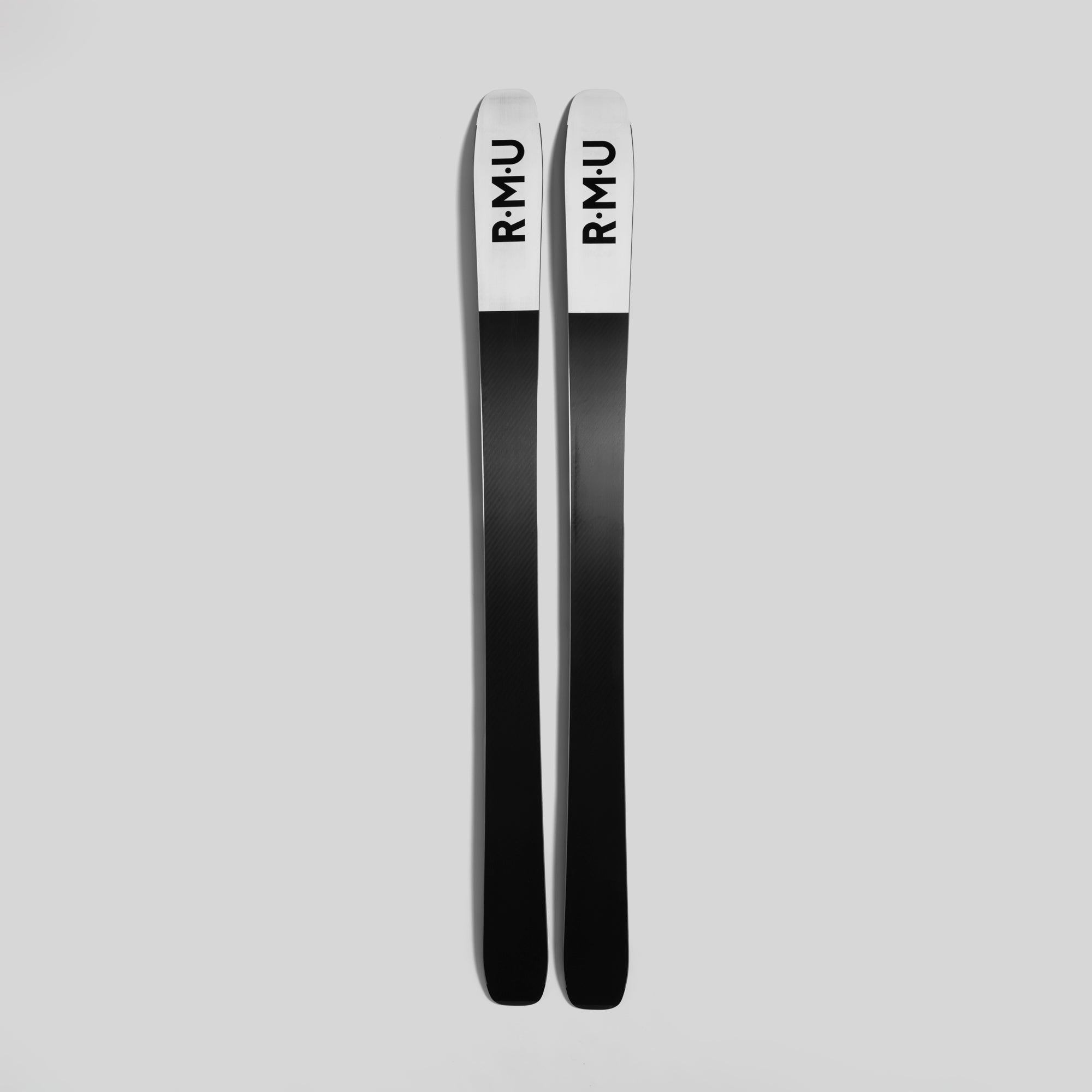 Two black skis with 'RMU' branding on a light gray background